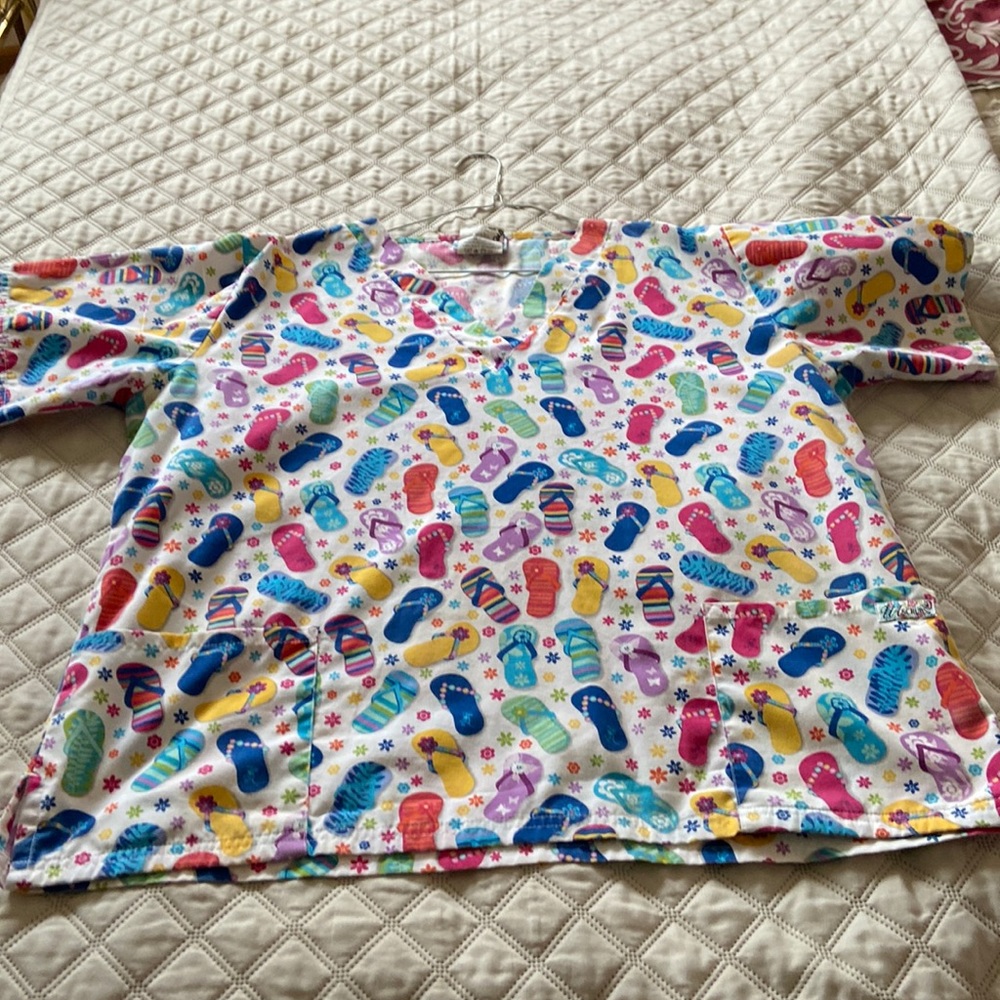 UA scrub top with flip flop pattern.